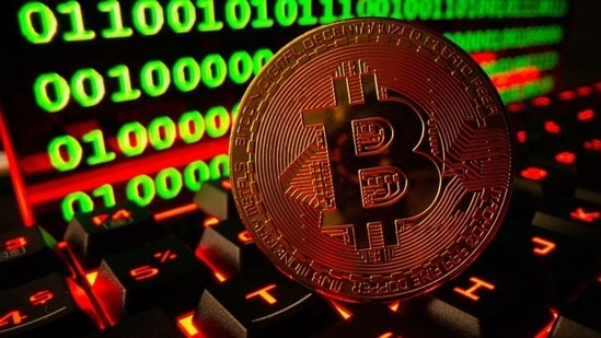 Bitcoin cryptocurrency representation is pictured on a keyboard in front of binary code.(REUTERS file photo)