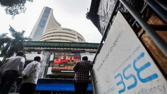 Market updates: People walk past the Bombay Stock Exchange building in Mumbai. (Reuters)