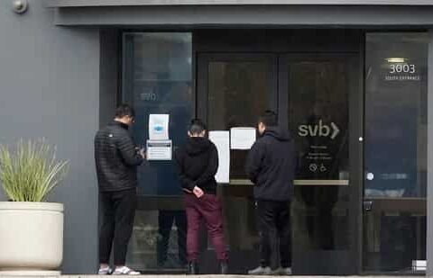 People look at signs posted outside of an entrance to Silicon Valley Bank in Santa Clara, California.(AP)