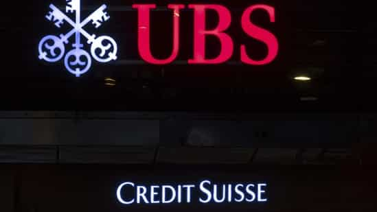 The illuminated logos of the Swiss banks Credit Suisse and UBS in Zurich, Switzerland. (AP)