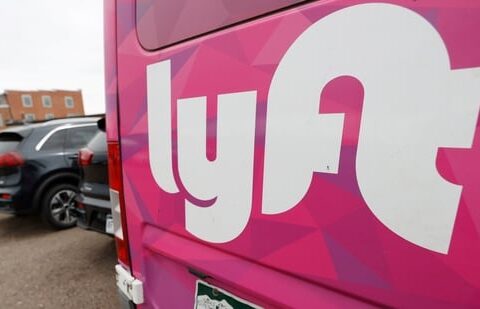 FILE - A Lyft ride-hailing vehicle is parked near Empower Field at Mile High in Denver on April 30, 2020. (AP Photo/David Zalubowski, File)