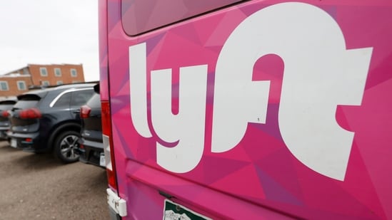 FILE - A Lyft ride-hailing vehicle is parked near Empower Field at Mile High in Denver on April 30, 2020. (AP Photo/David Zalubowski, File)