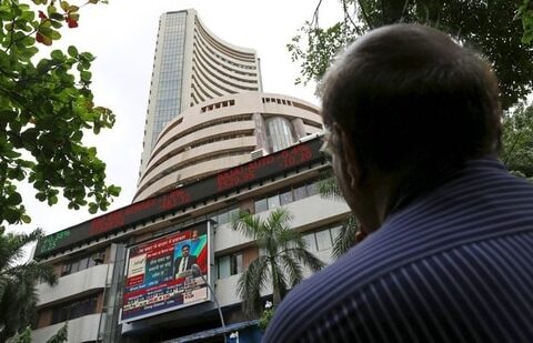 A man looks at a screen across a road displaying the Sensex on the facade of the Bombay Stock Exchange (BSE) building in Mumbai, India. (File image)(REUTERS)