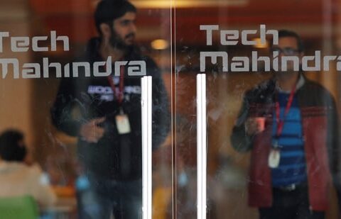 Employees walk outside the cafeteria in the Tech Mahindra office building in Noida on the outskirts of New Delhi.(REUTERS)