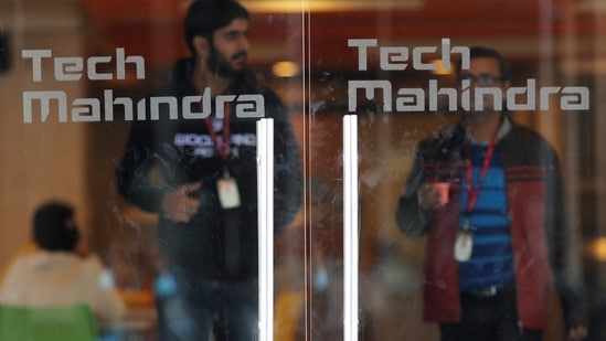 Employees walk outside the cafeteria in the Tech Mahindra office building in Noida on the outskirts of New Delhi.(REUTERS)