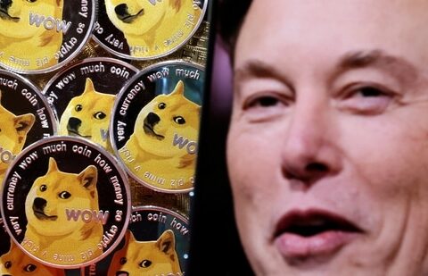 A photo of Elon Musk is displayed on a smartphone placed on representations of cryptocurrency Dogecoin. (Reuters)