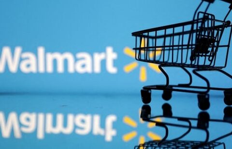 Shopping trolley is seen in front of Walmart logo.(REUTERS)