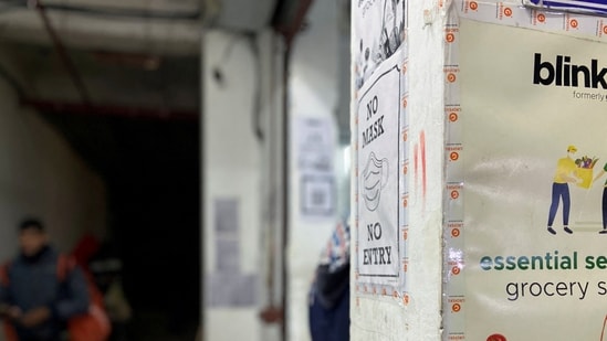 FILE PHOTO: A delivery person leaves a dark store of the SoftBank-funded Blinkit, an Indian company which is offering 10 minute deliveries for groceries, in New Delhi, India, January 19, 2022. (REUTERS/Anushree Fadnavis)