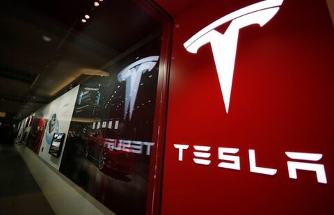 A sign bearing the Tesla company logo is displayed outside a Tesla store.(AP)