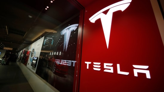 A sign bearing the Tesla company logo is displayed outside a Tesla store.(AP)