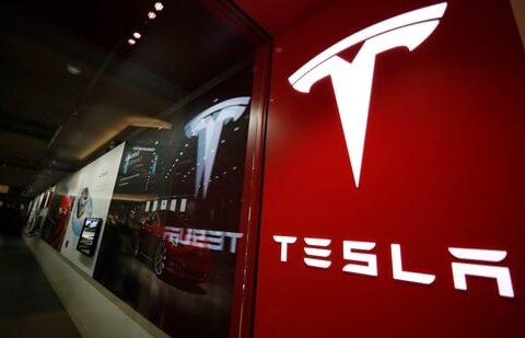 A sign bearing the Tesla company logo is displayed outside a Tesla store.(AP)