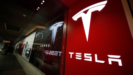 A sign bearing the Tesla company logo is displayed outside a Tesla store.(AP)