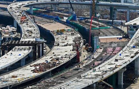 Labourers work at the construction site of a coastal road project near Haji Ali mosque in Mumbai on May 31. (AFP)