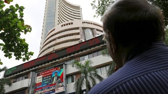 A man looks at a screen across a road displaying the Sensex on the facade of the Bombay Stock Exchange (BSE) building in Mumbai, India. (File image)(REUTERS)