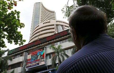 Sensex, Nifty updates: A man looks at a screen across a road displaying the Sensex on the facade of the Bombay Stock Exchange (BSE) building in Mumbai, India. (REUTERS)