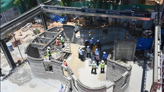 Workers indulge in their work at the construction site of first-of-its-kind 3D printed post office building, in Bengaluru on April 11 (PTI)