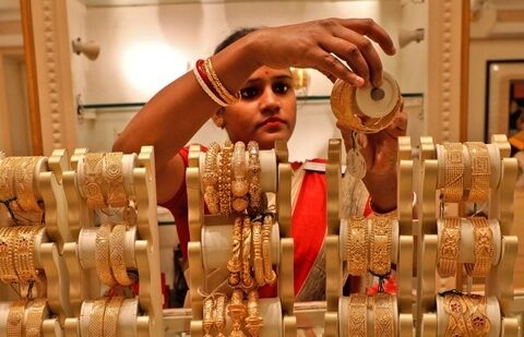 A saleswoman shows gold bangles to a customer at a jewellery showroom in Kolkata, India.(REUTERS/ File)