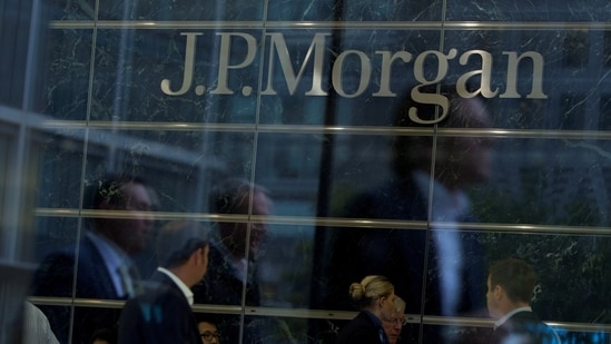 Workers are reflected in the windows of the Canary Wharf offices of JP Morgan in London.(Reuters)