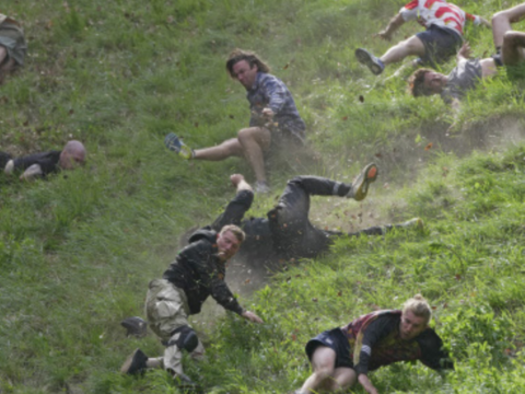 Rolling thunder: Contestants chase cheese wheel down a hill in chaotic UK race