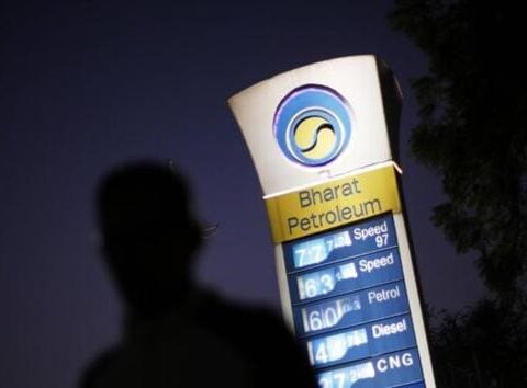 A Bharat Petroleum oil pump station displays the price of unleaded petrol and Diesel as a pedestrian walks past in New Delhi.(Reuters)