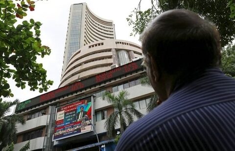 A man looks at a screen across a road displaying the Sensex on the facade of the Bombay Stock Exchange (BSE) building in Mumbai, India. (File image)(REUTERS)