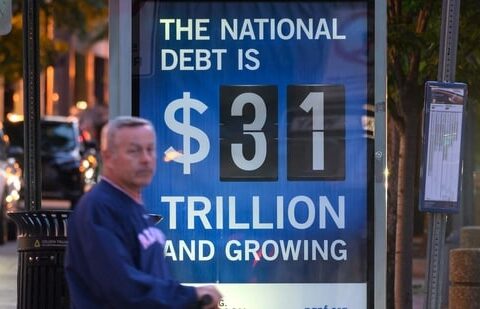 A poster at a bus shelter shows the national debt in Washington, DC.(AFP)