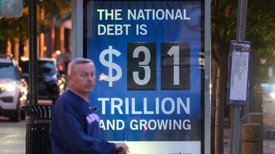 A poster at a bus shelter shows the national debt in Washington, DC.(AFP)