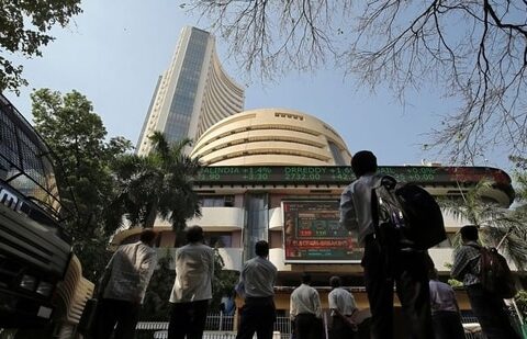 People look at a screen displaying the Sensex results on the facade of the Bombay Stock Exchange (BSE) building in Mumbai.(Reuters)