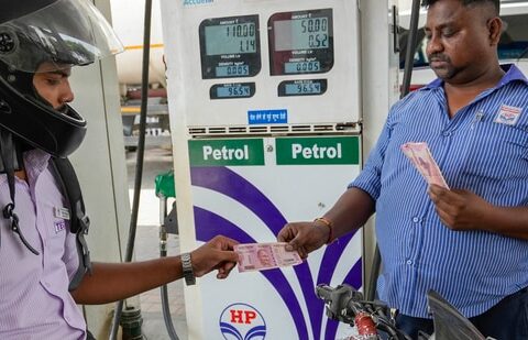 A motorcyclist makes payment using Rs. 2000 note, at a petrol pump, in Lucknow. (PTI)