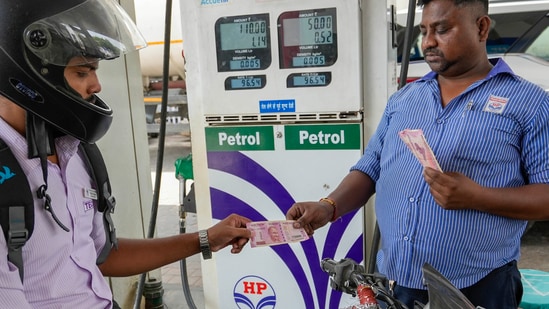 A motorcyclist makes payment using Rs. 2000 note, at a petrol pump, in Lucknow. (PTI)