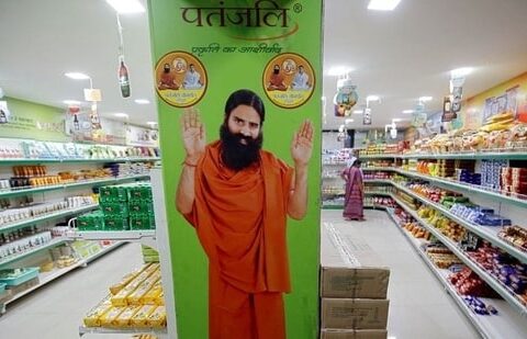 A hoarding with an image of Baba Ramdev is seen inside a Patanjali store. (REUTERS)