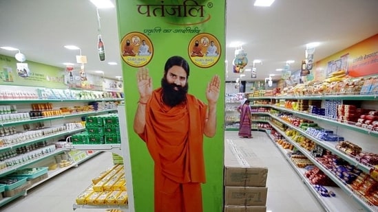 A hoarding with an image of Baba Ramdev is seen inside a Patanjali store. (REUTERS)