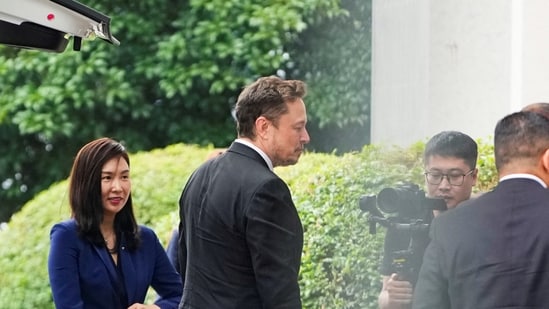 Tesla Chief Executive Officer Elon Musk walks at Shanghai Hongqiao International Airport in Shanghai.(Reuters)