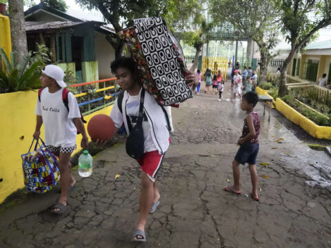 Rains unleashed by typhoon worry thousands of people fleeing restive Philippine volcano