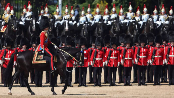 Troops feel the heat, and several faint, as Prince William reviews military parade