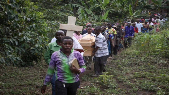 Ugandan border town buries victims of rebel massacre that left 42 dead, mostly students