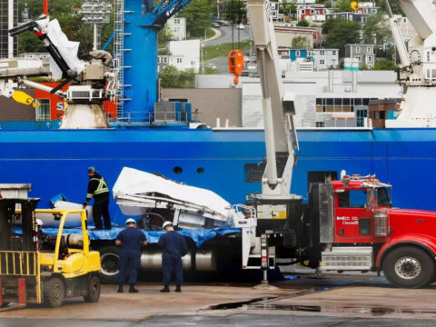 Presumed human remains, shattered Titanic submersible returned to shore