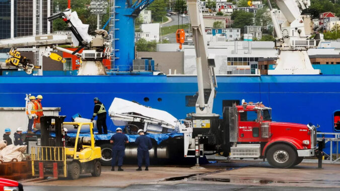 Presumed human remains, shattered Titanic submersible returned to shore