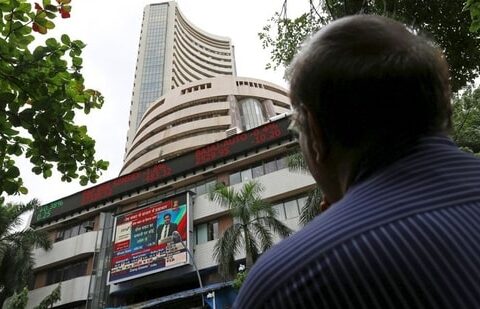 A man looks at a screen across a road displaying the Sensex on the facade of the Bombay Stock Exchange (BSE) building in Mumbai, India. (File image)(REUTERS)