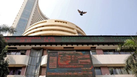 A bird flies past a screen displaying the Sensex results on the facade of the Bombay Stock Exchange (BSE) building in Mumbai.(REUTERS)