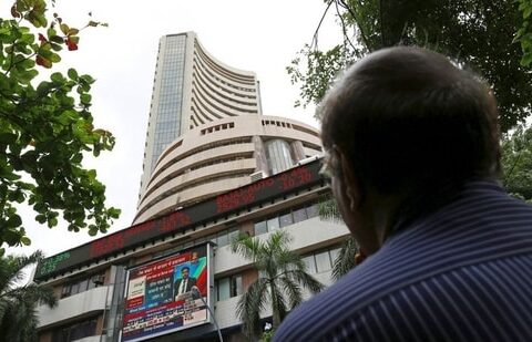 A man looks at a screen across a road displaying the Sensex on the facade of the Bombay Stock Exchange (BSE) building in Mumbai, India. (File image)(REUTERS)