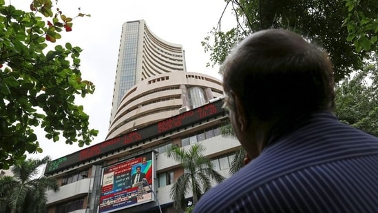 A man looks at a screen across a road displaying the Sensex on the facade of the Bombay Stock Exchange (BSE) building in Mumbai, India. (File image)(REUTERS)