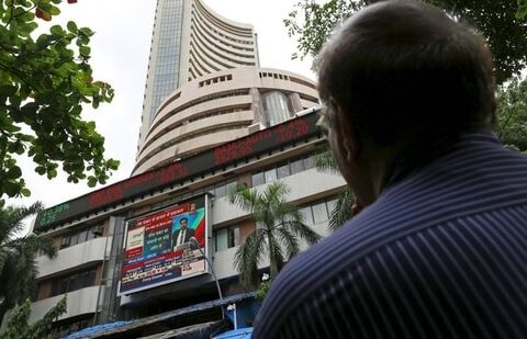 A man looks at a screen across a road displaying the Sensex on the facade of the Bombay Stock Exchange (BSE) building in Mumbai, India. (File image)(REUTERS)