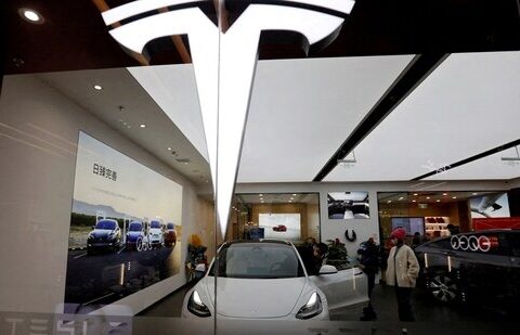 Visitors check a Tesla Model 3 car next to a Model Y displayed at a showroom of the U.S. electric vehicle (EV) maker in Beijing, China.(REUTERS)