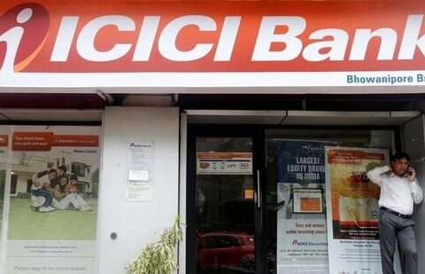 A man speaks on the phone outside an ICICI Bank branch in Kolkata, India.(REUTERS)