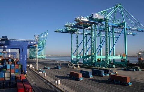 A crane lifts a shipping container at an automated port in Tianjin, China.(AP)