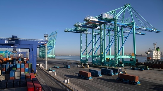 A crane lifts a shipping container at an automated port in Tianjin, China.(AP)