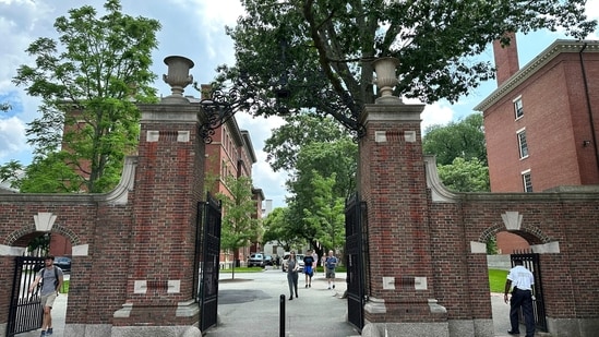 FILE - Students walk through a gate at Harvard University, Thursday, June 29, 2023, in Cambridge, Mass. Anonymous comments with racist, sexist and abusive messages that were posted for years on a jobs-related website for economists originated from numerous leading U.S. universities, including Harvard, Stanford, and the University of Chicago, according to research released Thursday. (AP Photo/Michael Casey, File)(AP)