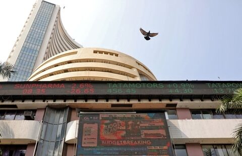 A bird flies past a screen displaying the Sensex results on the facade of the Bombay Stock Exchange (BSE) building in Mumbai.(REUTERS)