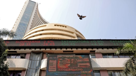 A bird flies past a screen displaying the Sensex results on the facade of the Bombay Stock Exchange (BSE) building in Mumbai.(REUTERS)